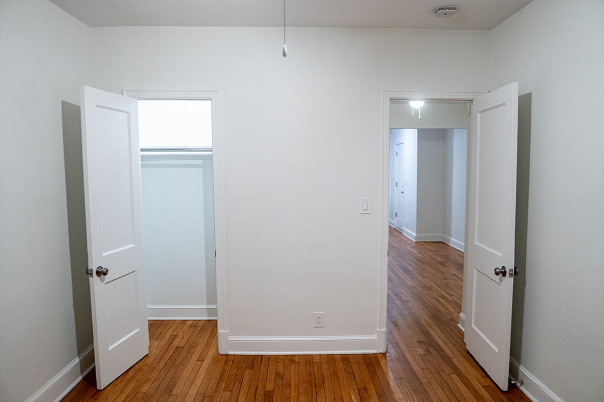 Clean look at a renovated bedroom with new drywall and fresh painting