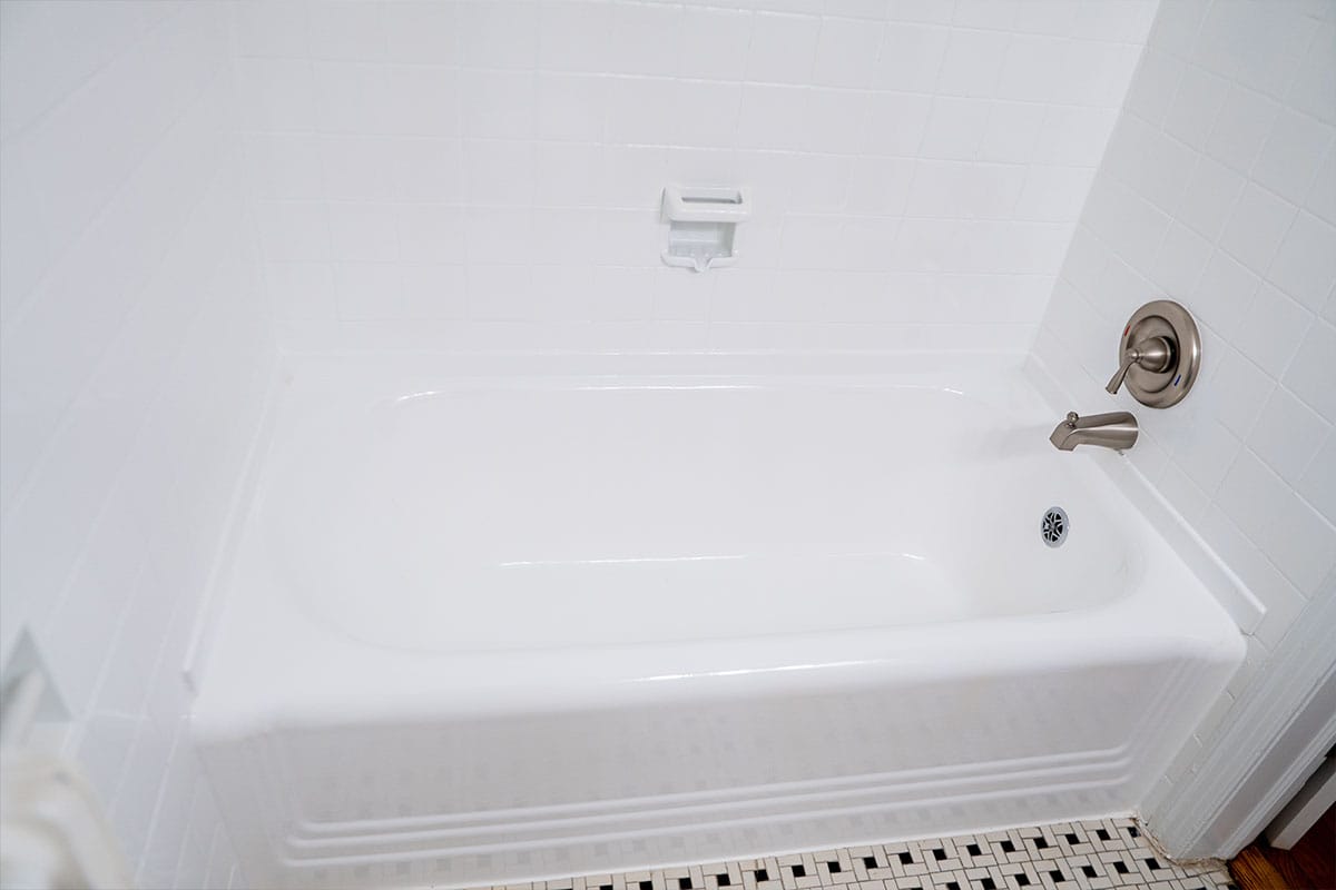 Close up on bathtub renovated by JVV Remodeling inside an apartment bathroom