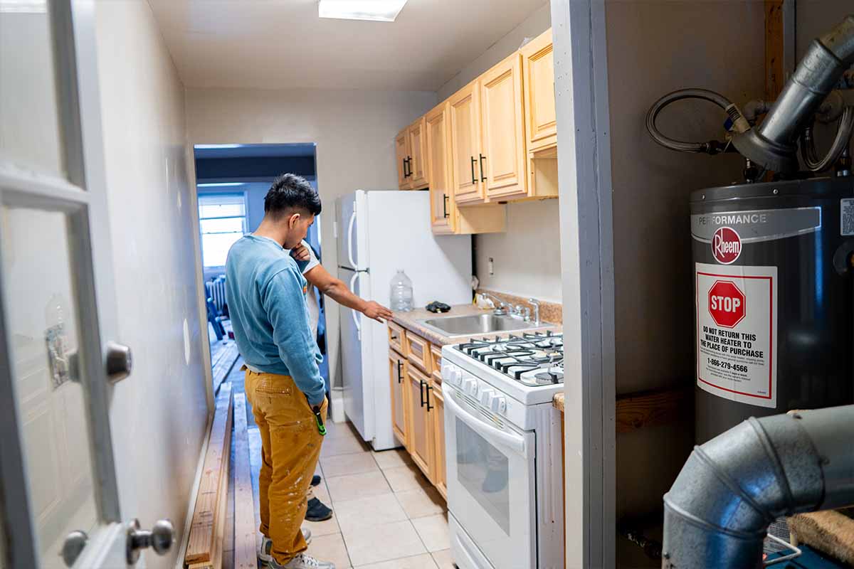 JVV Remodeling team analyzing outdated kitchen before renovating it