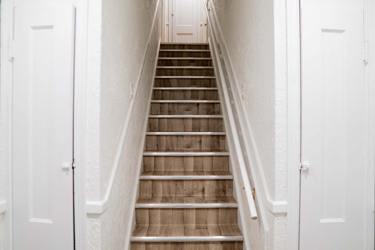 Renovated stairway inside an apartment building completed by JVV Remodeling