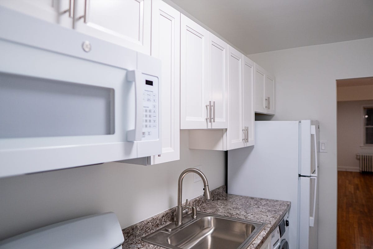 Side view at white cabinets installed inside a kitchen located in DC by JVV Remodeling
