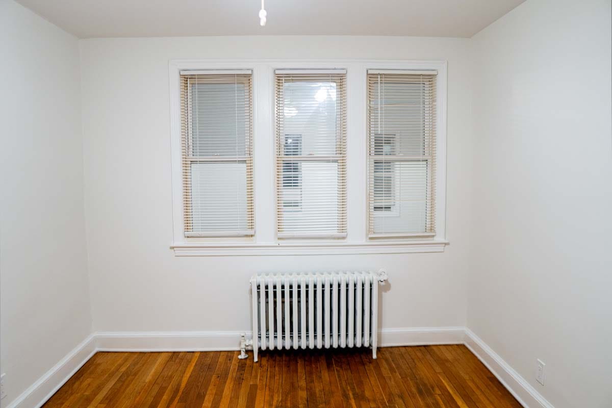 Touchup on the walls of a apartment bedroom with new drywall and painting