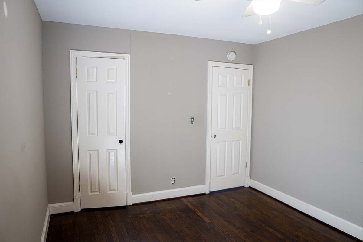 Wide view of a bedroom before being painted by JVV Remodeling