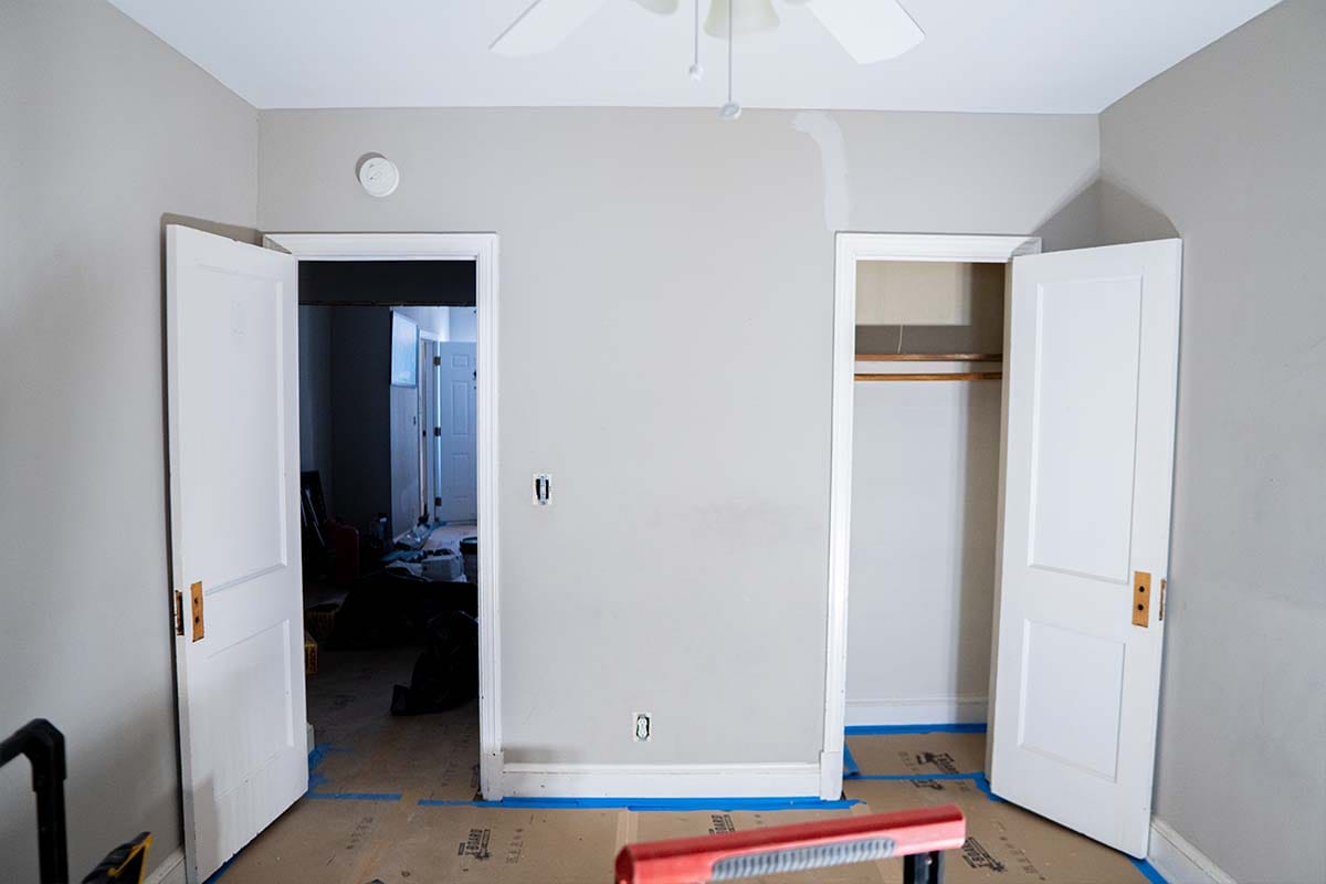 Wide view of an apartment bedroom before being painted by JVV Remodeling