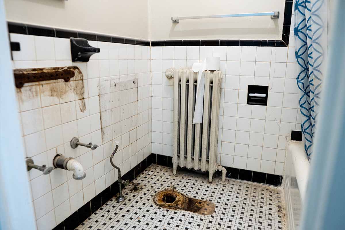 Wide view of an outdated bathroom inside a DC apartment