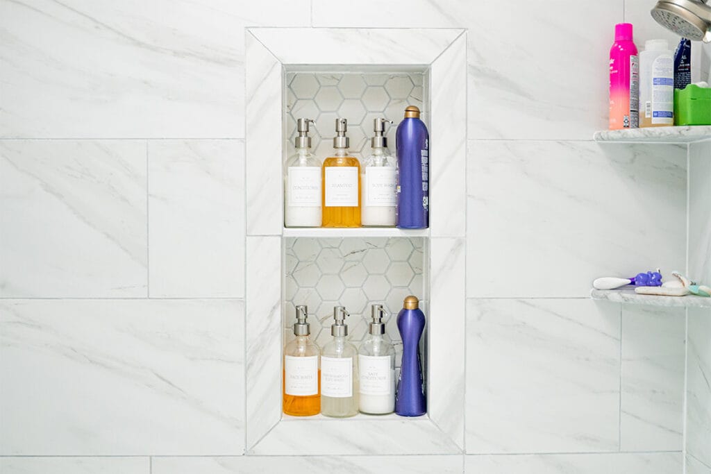 Ceramic shower niche installed in a tub and shower inside a DC hallway bathroom