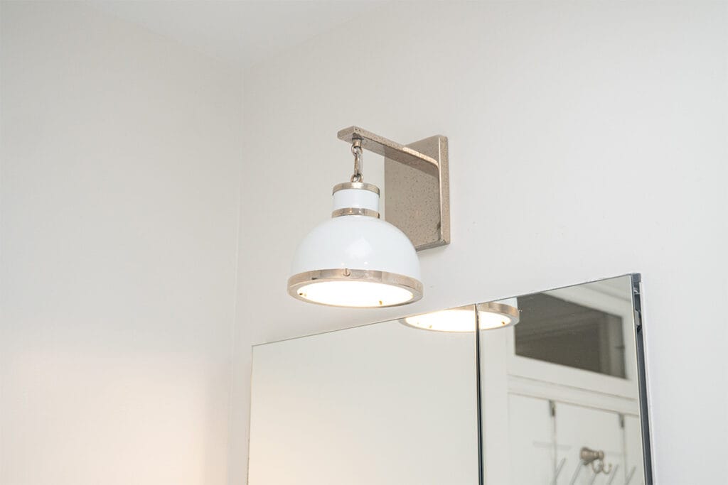 Closeup on new lighting fixtures installed inside a halway bathroom