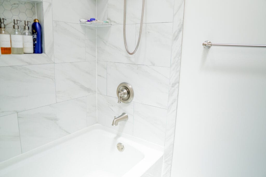 Closeup on shower faucet inside a DC hallway bathroom