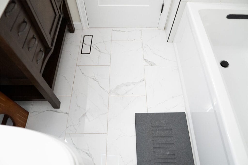 Closeup on white marble ceramic flooring installed in a hallway bathroom in Virginia