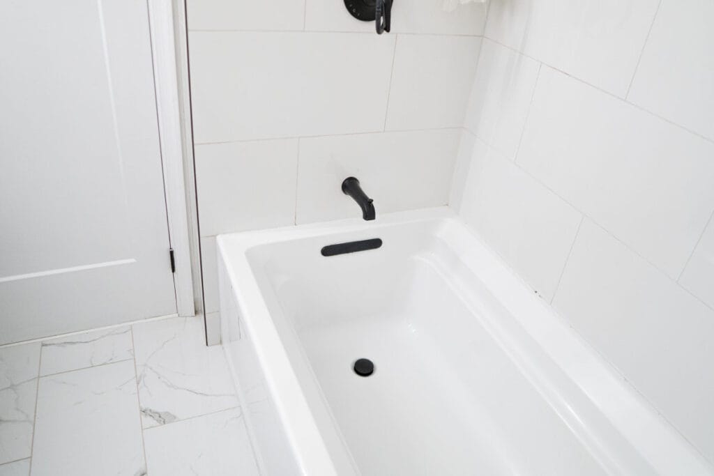 New black shower faucet instaled in a Virginia hallway bathroom