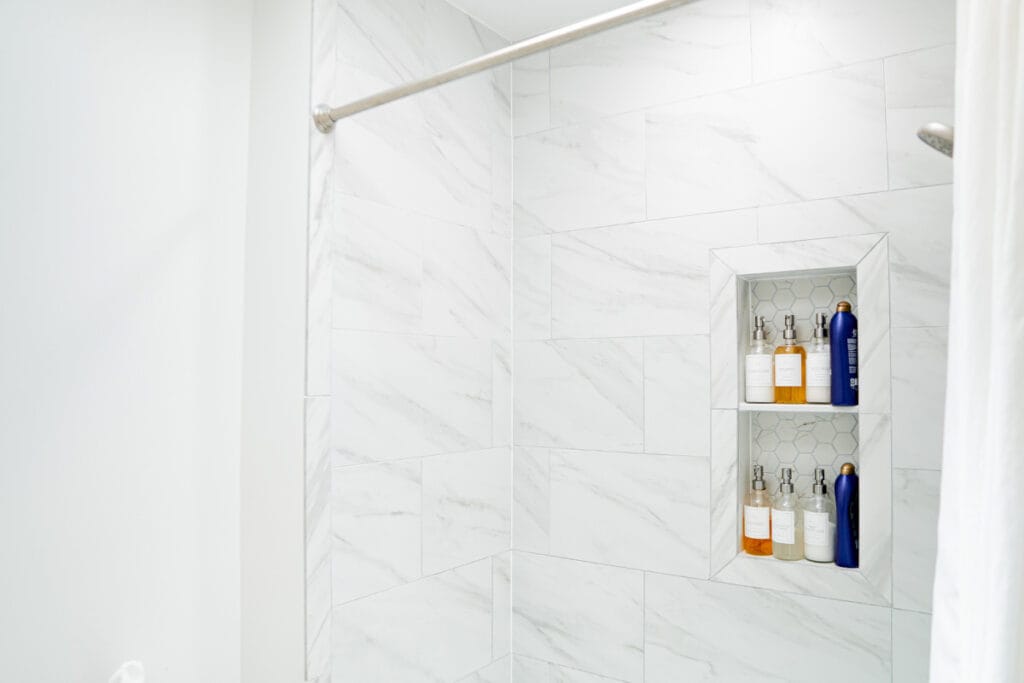 New ceramic shower walls installed in a DC hallway bathroom