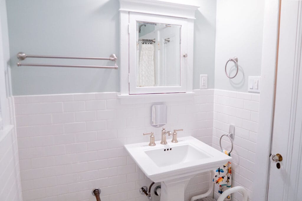 New ceramic walls installed halfway up the bathroom walls in a DC hallway bathroom