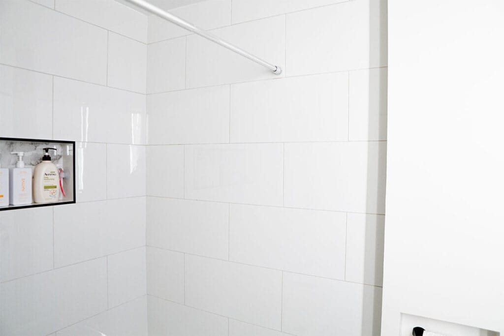 New white ceramic shower walls installed in a hallway bathroom in Virginia