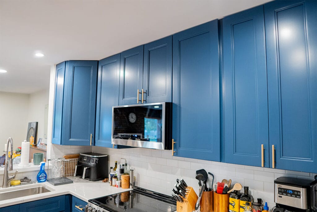Wide view of dark blue wooden cabinets installed in a Virginia kitchen